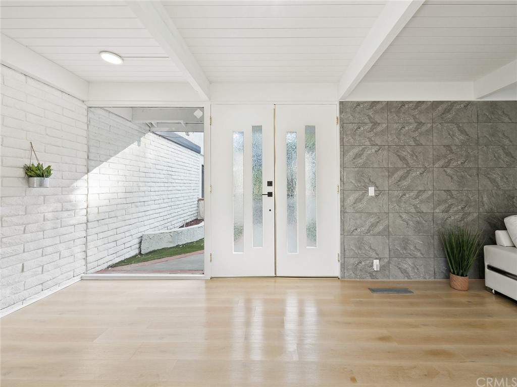 5100 Queen Street Riverside, CA 92506 - Photo 5 of 75 a view of an empty room with wooden floor and a window