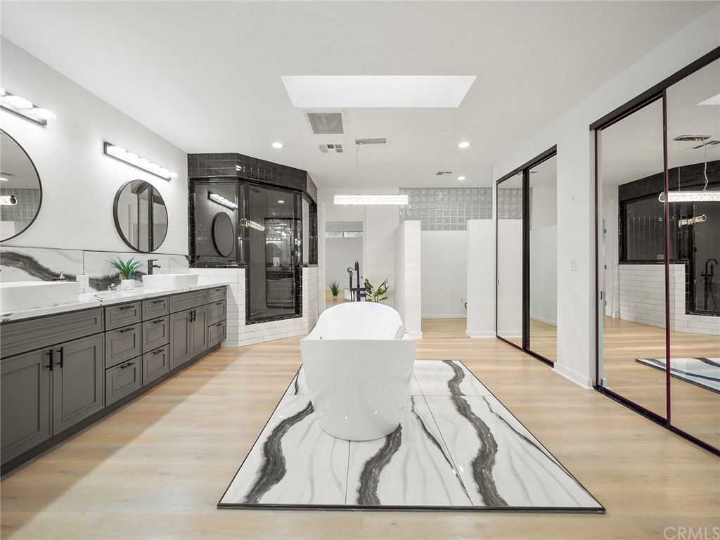 5100 Queen Street Riverside, CA 92506 - Photo 57 of 75 a spacious bathroom with a double vanity sink and a mirror