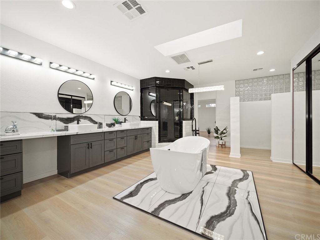 5100 Queen Street Riverside, CA 92506 - Photo 58 of 75 a large bathroom with a double vanity sink a mirror and a shower