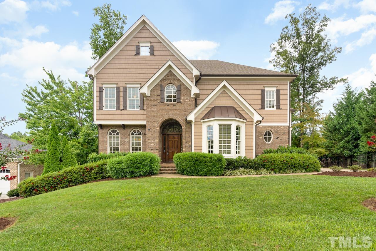 5004 Greyhawk Place Apex, NC 27539 - Photo 1 of 36 a front view of a house with a yard and trees