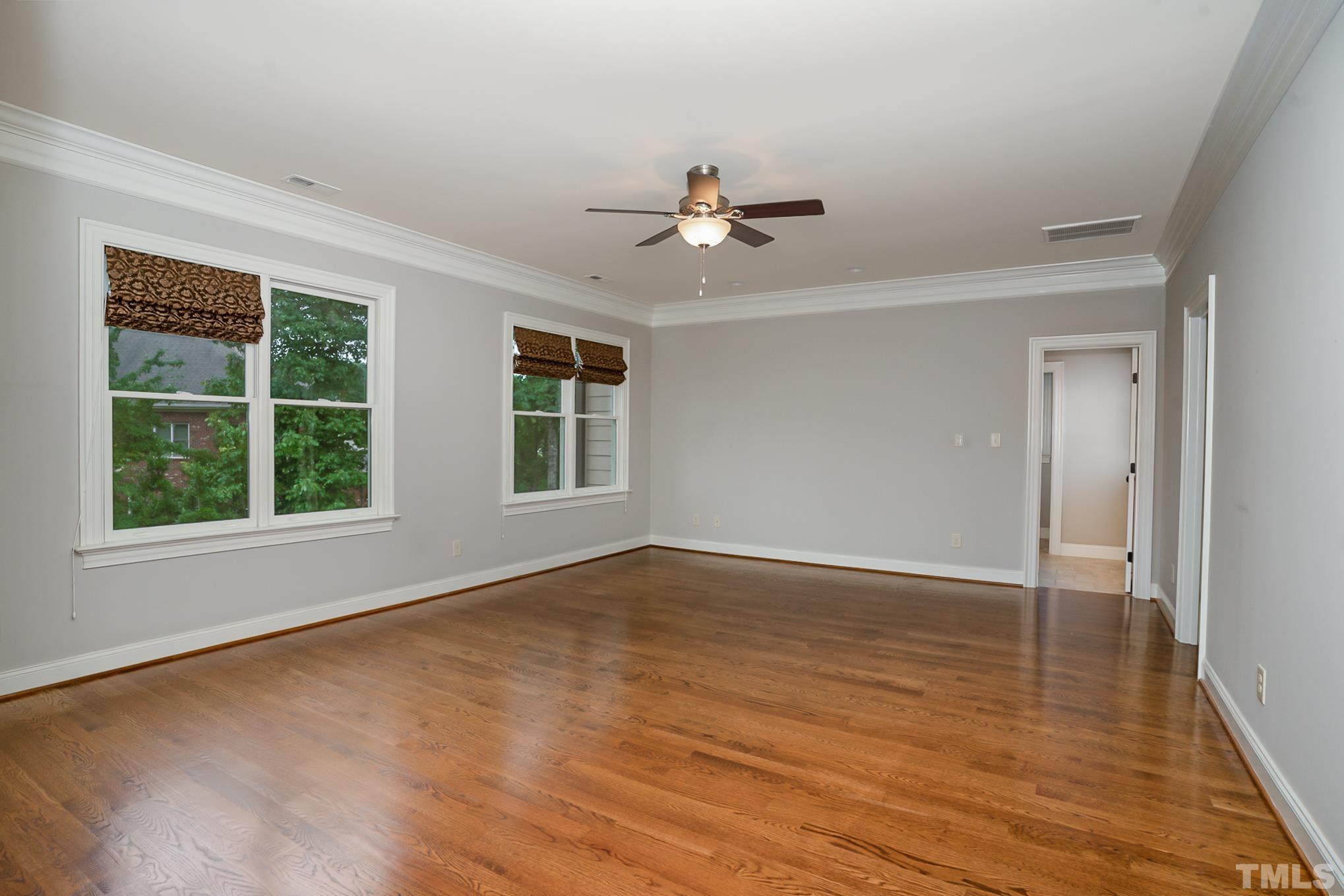 5004 Greyhawk Place Apex, NC 27539 - Photo 13 of 36 a view of an empty room with a window and wooden floor