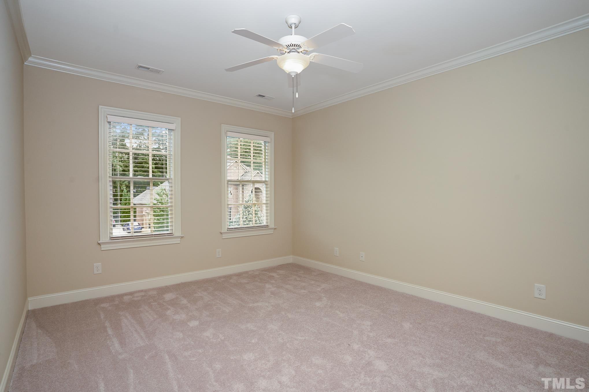 5004 Greyhawk Place Apex, NC 27539 - Photo 16 of 36 an empty room with a window and a fan
