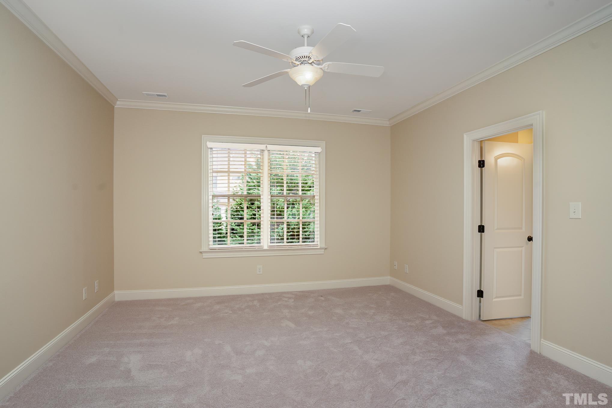 5004 Greyhawk Place Apex, NC 27539 - Photo 20 of 36 an empty room with a window and a ceiling fan
