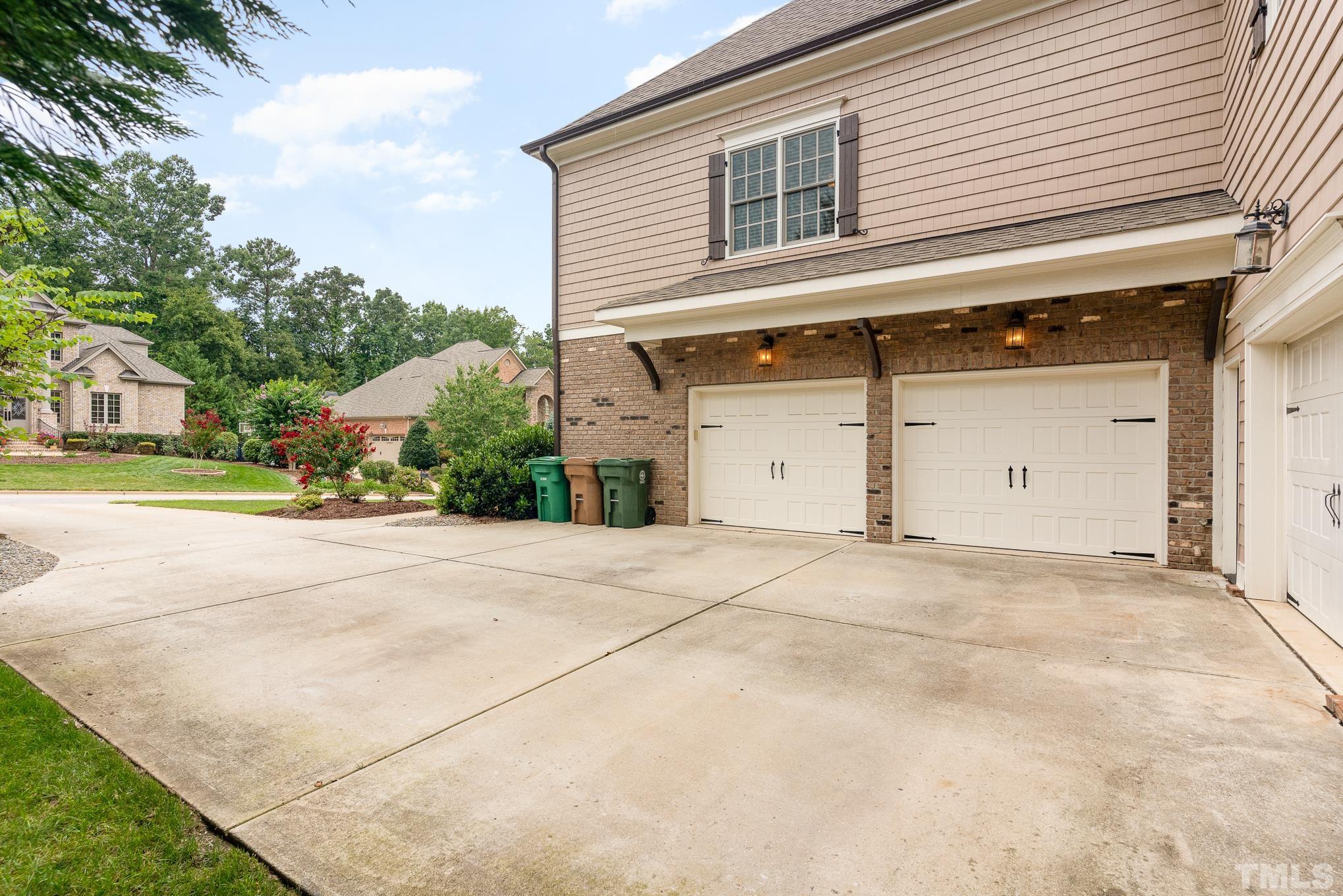 5004 Greyhawk Place Apex, NC 27539 - Photo 2 of 36 a front view of a house with a yard and garage
