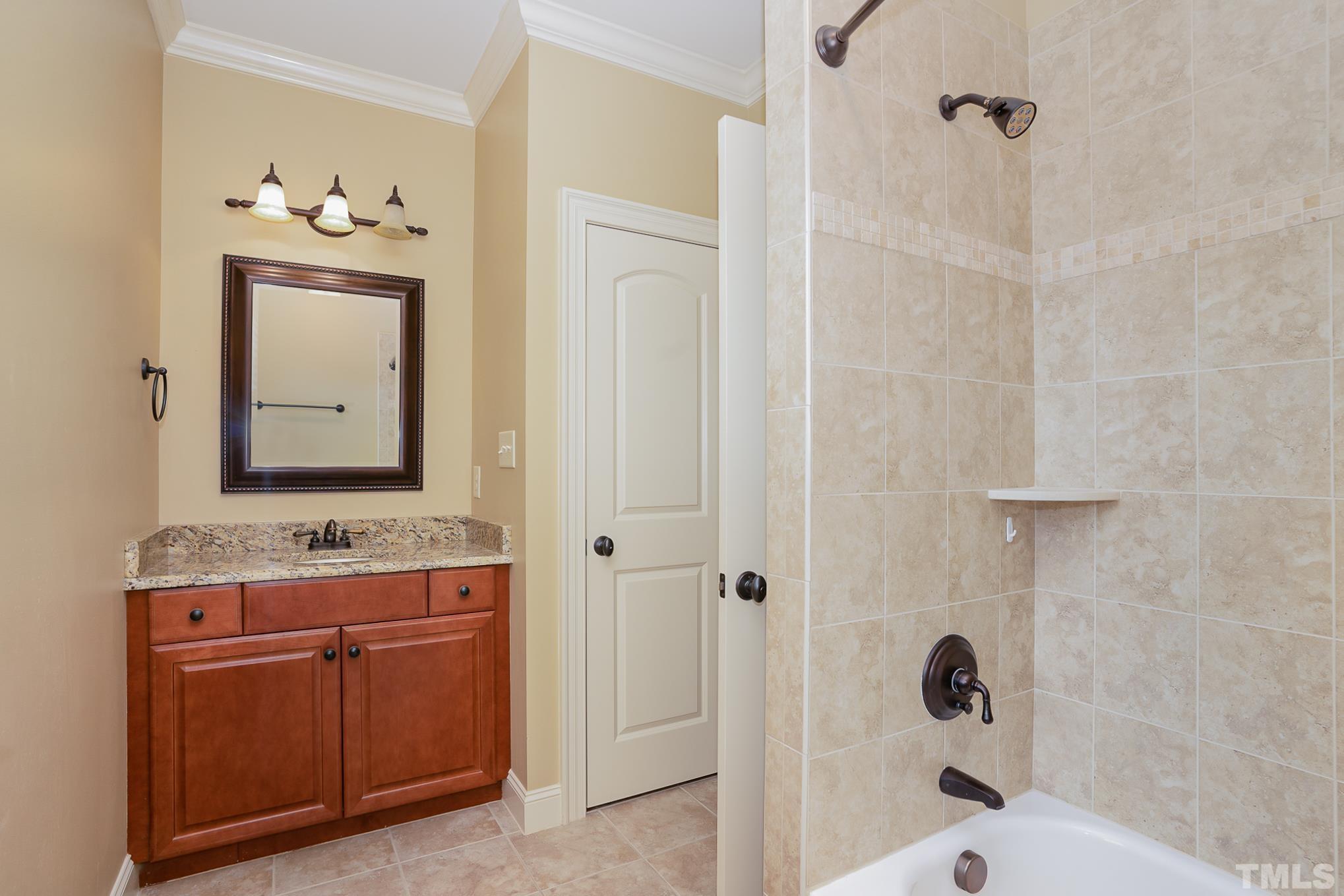 5004 Greyhawk Place Apex, NC 27539 - Photo 21 of 36 a bathroom with a sink a toilet and shower