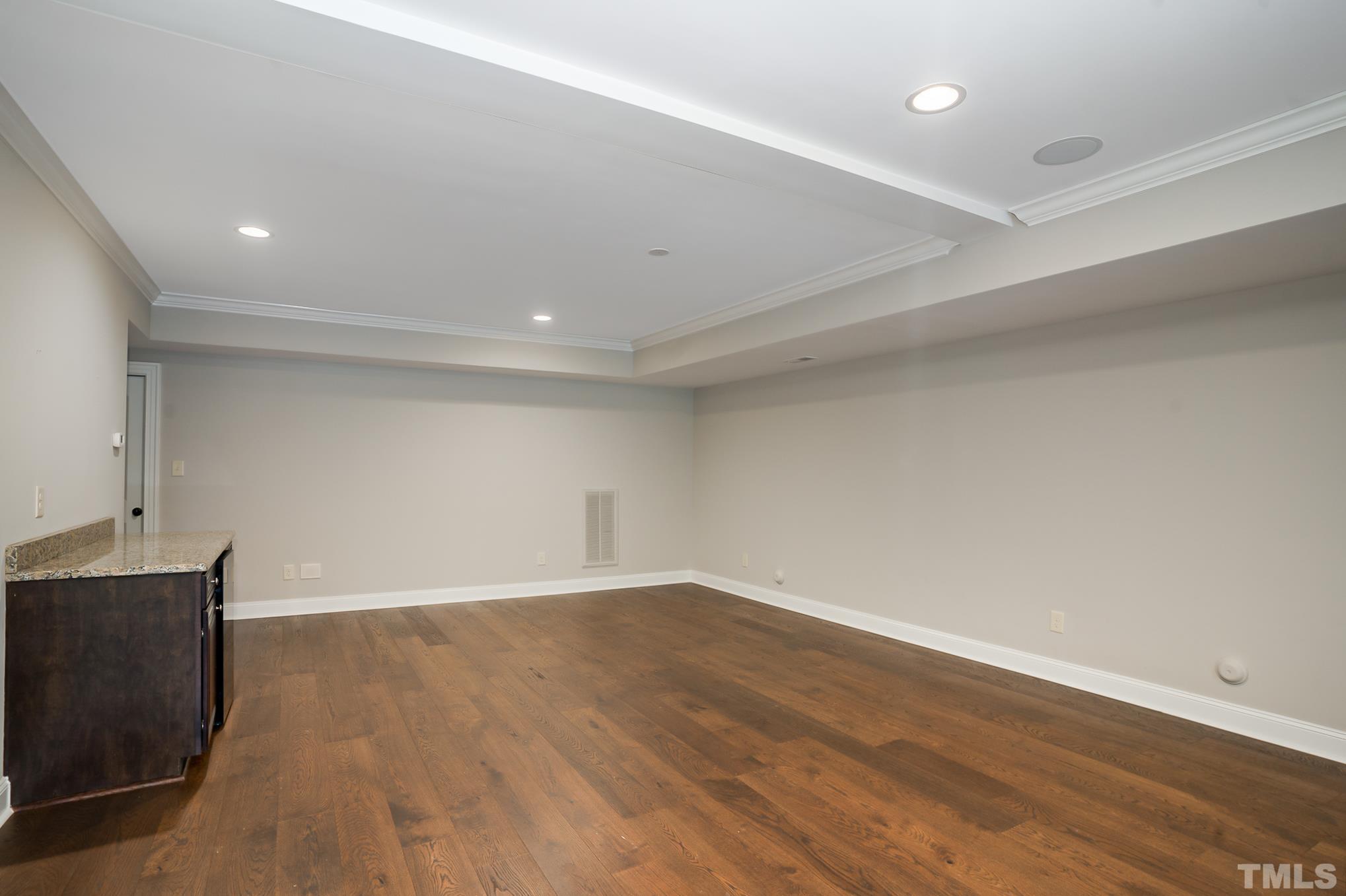 5004 Greyhawk Place Apex, NC 27539 - Photo 23 of 36 a view of an empty room with wooden floor