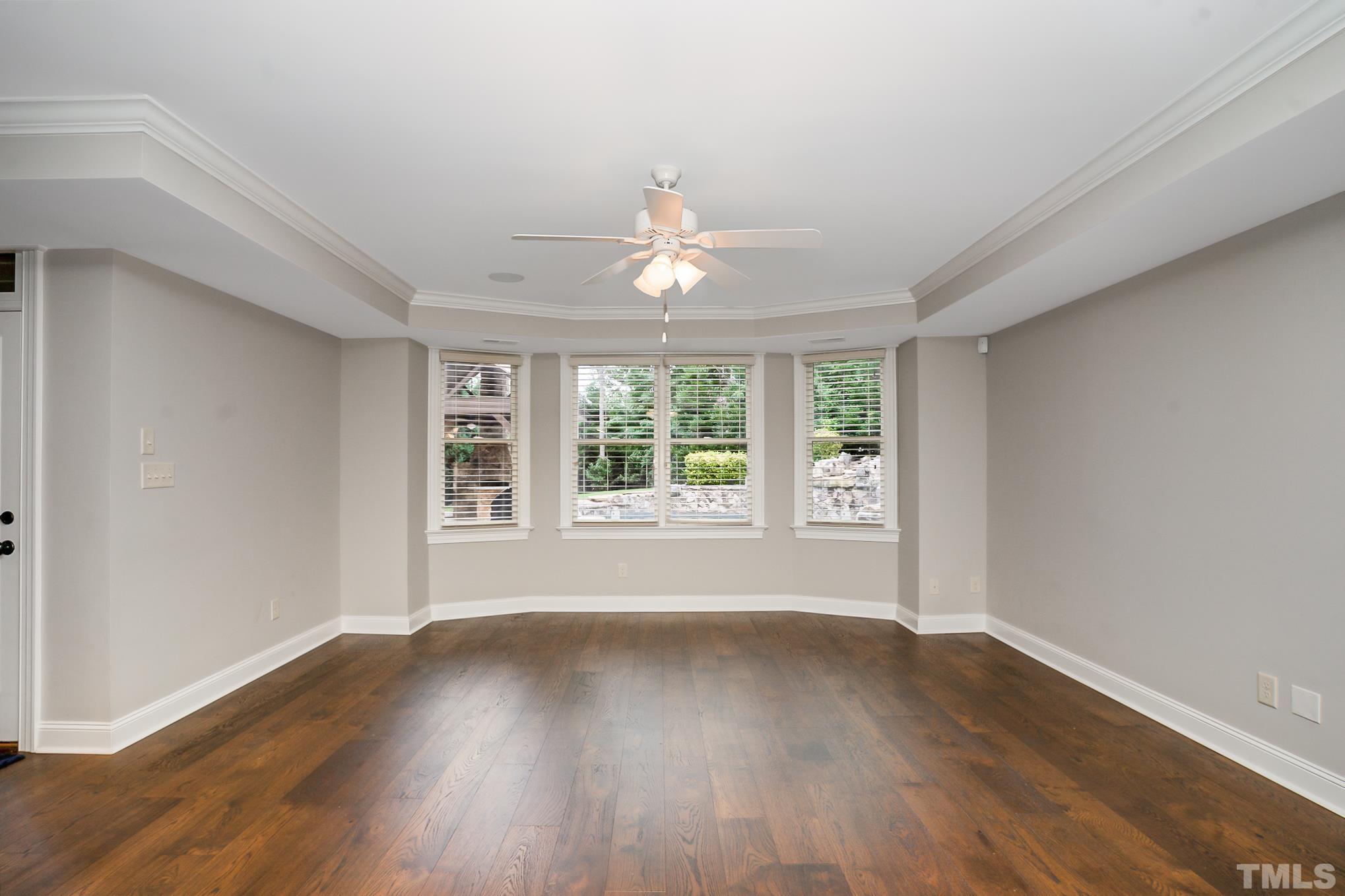 5004 Greyhawk Place Apex, NC 27539 - Photo 25 of 36 a view of an empty room with wooden floor and a window