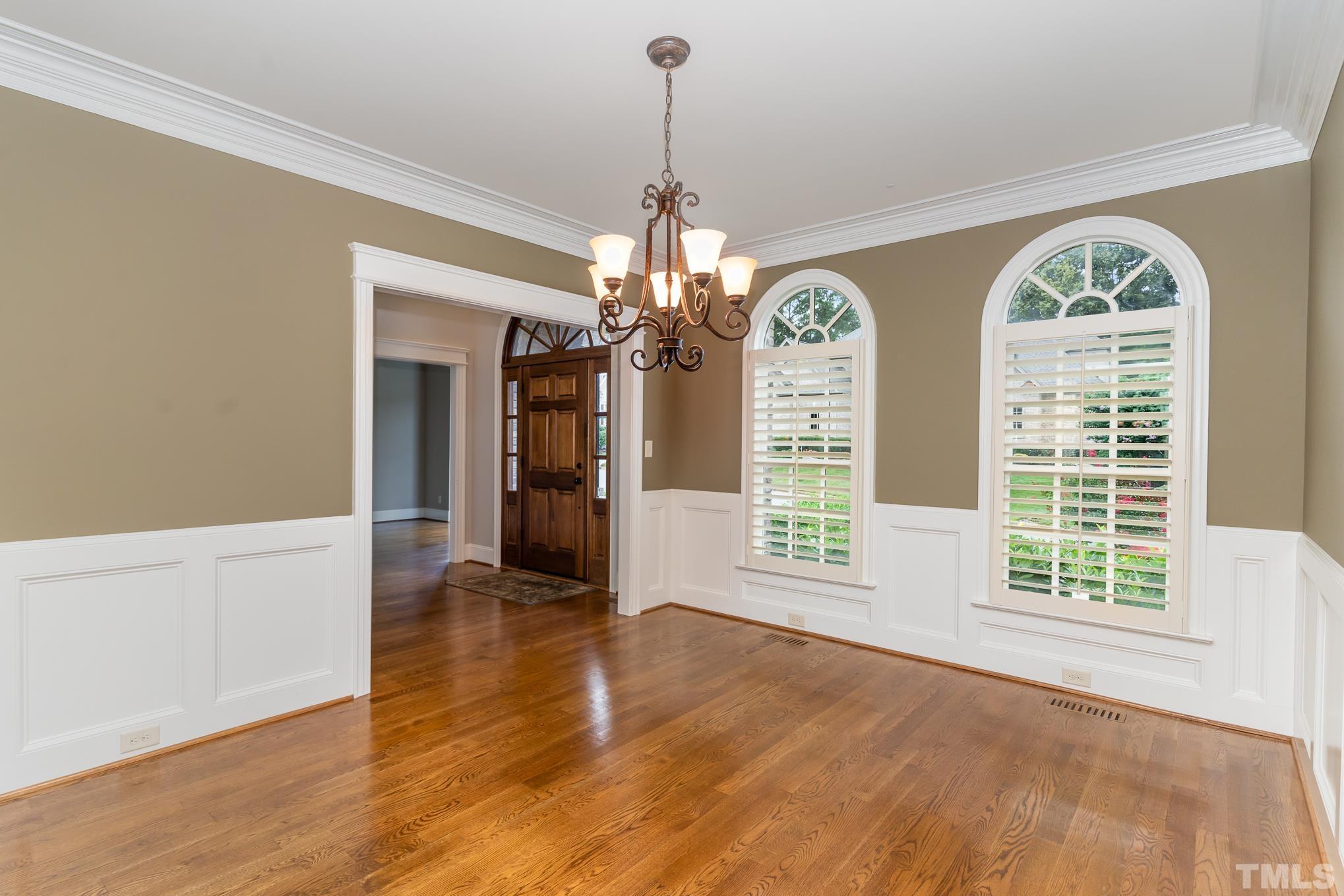 5004 Greyhawk Place Apex, NC 27539 - Photo 4 of 36 a view of an empty room with a window and wooden floor