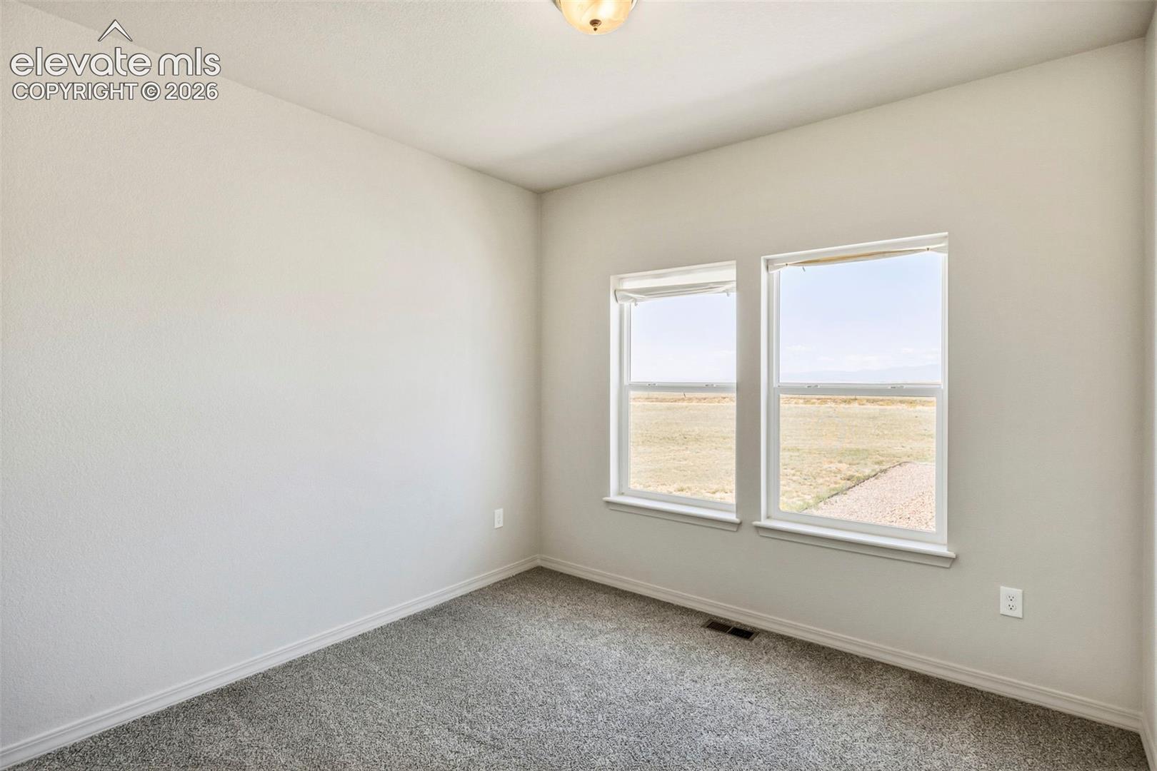 3955 North Yoder Road Yoder, CO 80864 - Photo 26 of 38 Neutral-toned room with light gray walls and plush gray carpeting