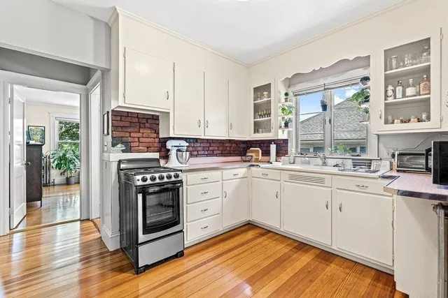 a kitchen with stainless steel appliances granite countertop a stove and cabinets