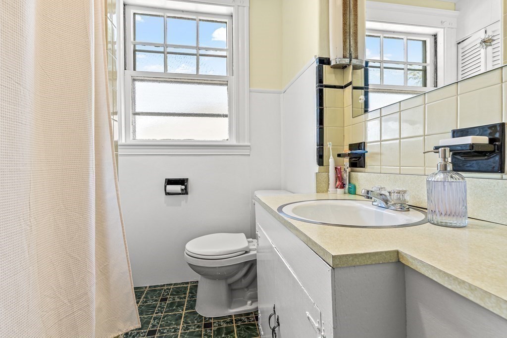 10 Chestnut Street, Unit 3 Melrose, MA 02176 - Photo 6 of 6 a bathroom with a sink toilet and window
