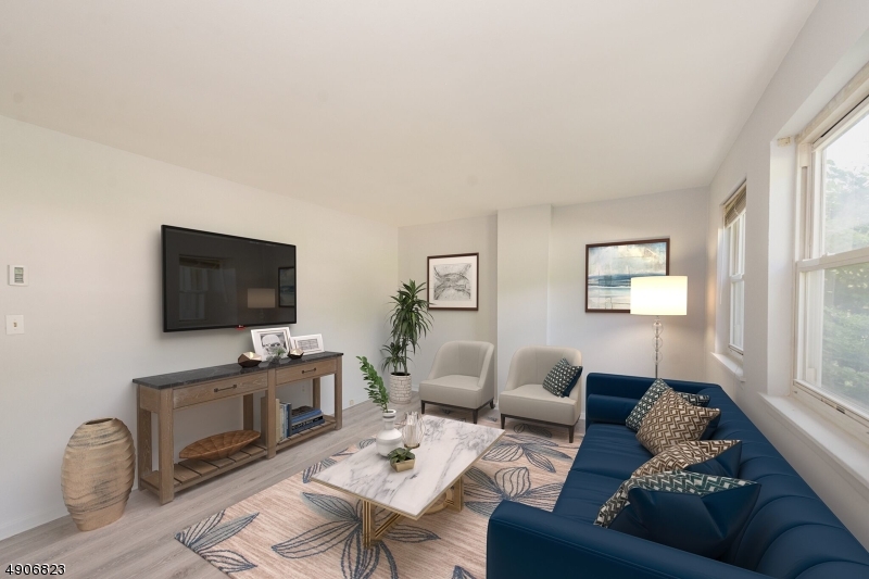 62 King Cole Road, Unit 14 Hamburg, NJ 07419 - Photo 1 of 7 a living room with furniture a flat screen tv and a window