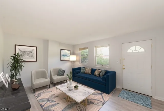 a living room with furniture and a potted plant