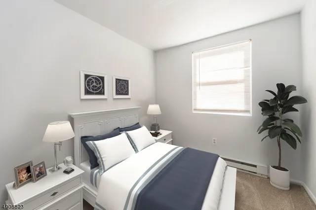a bedroom with a bed and a potted plant