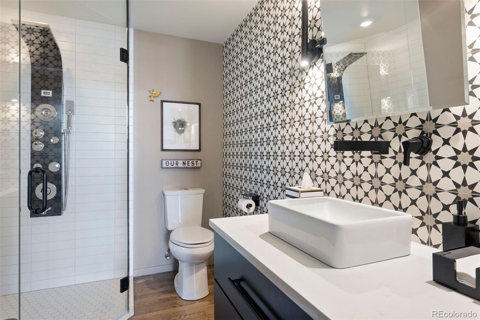 1801 Wynkoop Street, Unit 603 Denver, CO 80202 - Photo 11 of 40 a bathroom with a sink toilet and shower