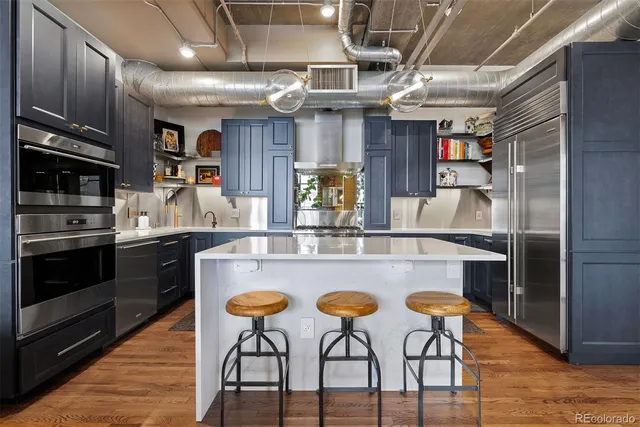 a kitchen with a stove a sink and a refrigerator