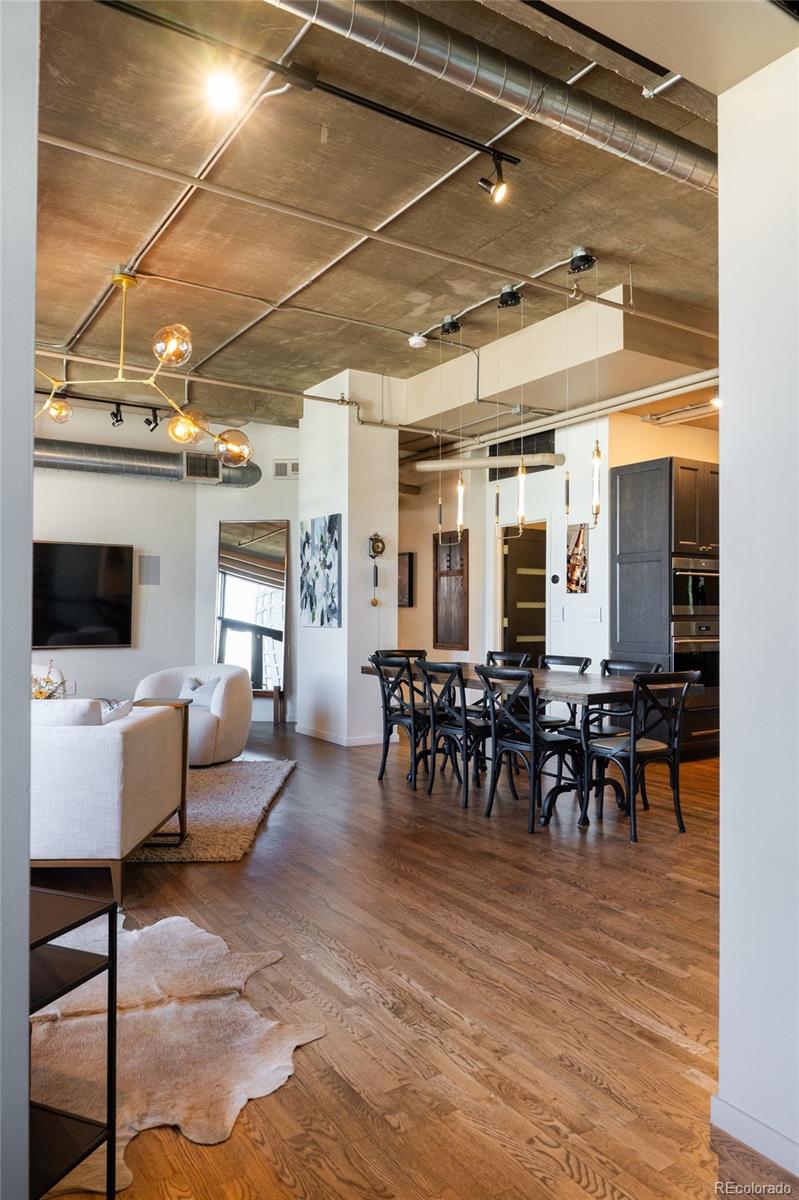 1801 Wynkoop Street, Unit 603 Denver, CO 80202 - Photo 19 of 40 a view of a dining room with furniture and wooden floor