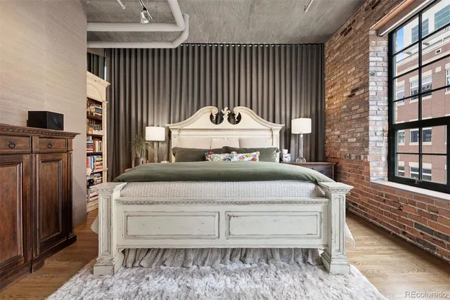 a bed room with a bed and a chair