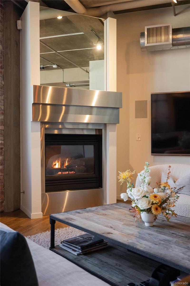 1801 Wynkoop Street, Unit 603 Denver, CO 80202 - Photo 25 of 40 a living room with furniture and a fireplace