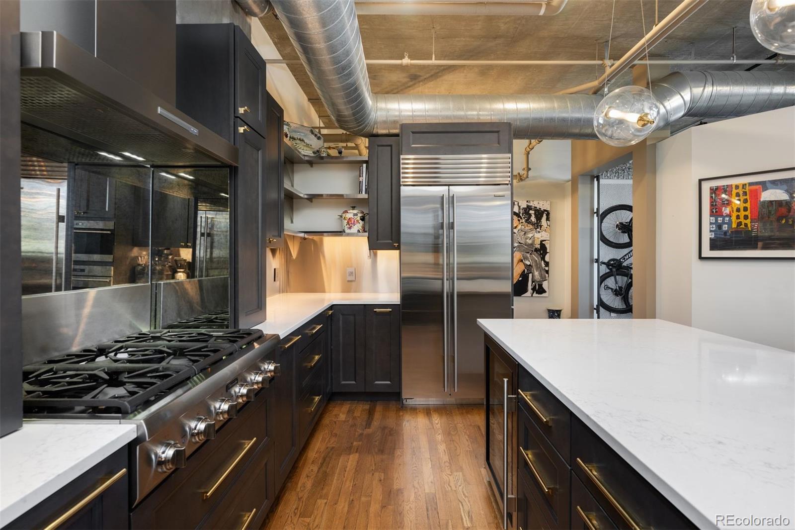 1801 Wynkoop Street, Unit 603 Denver, CO 80202 - Photo 26 of 40 a kitchen with stainless steel appliances granite countertop a stove a refrigerator and a wooden cabinets