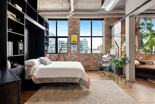 a view of a hallway with wooden floor and entryway