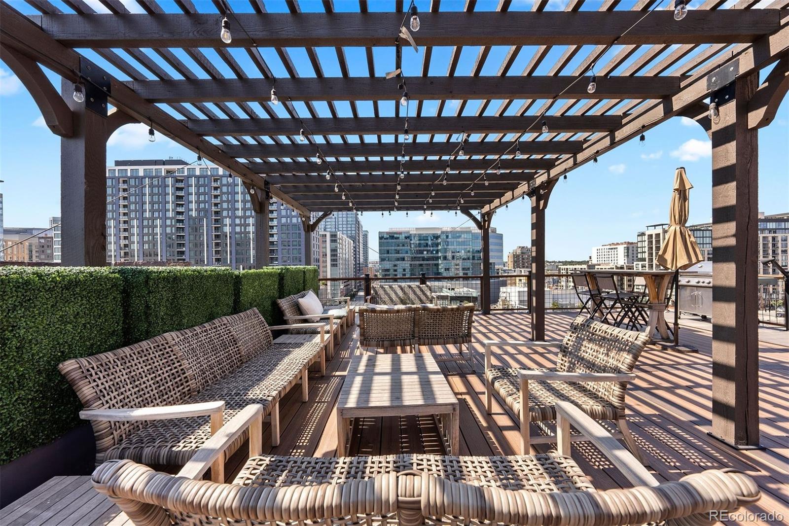 1801 Wynkoop Street, Unit 603 Denver, CO 80202 - Photo 34 of 40 a view of a patio with table and chairs with wooden floor and fence