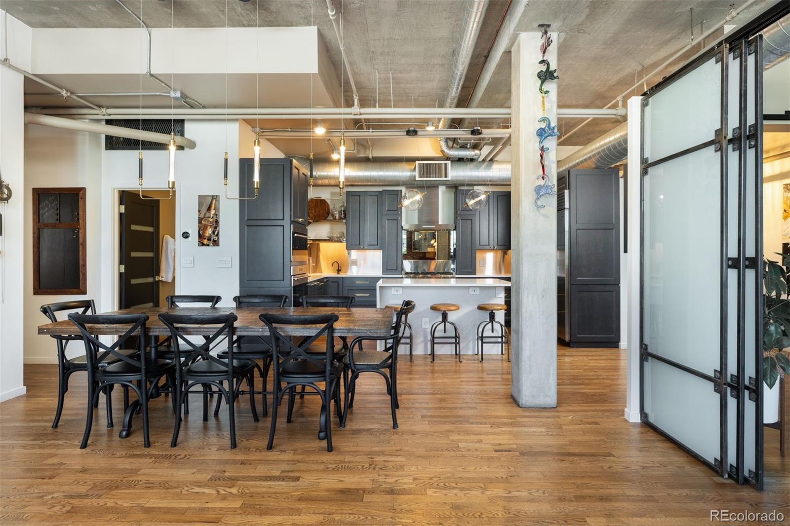 1801 Wynkoop Street, Unit 603 Denver, CO 80202 - Photo 9 of 40 a view of a dining room with lots of furniture and white walls