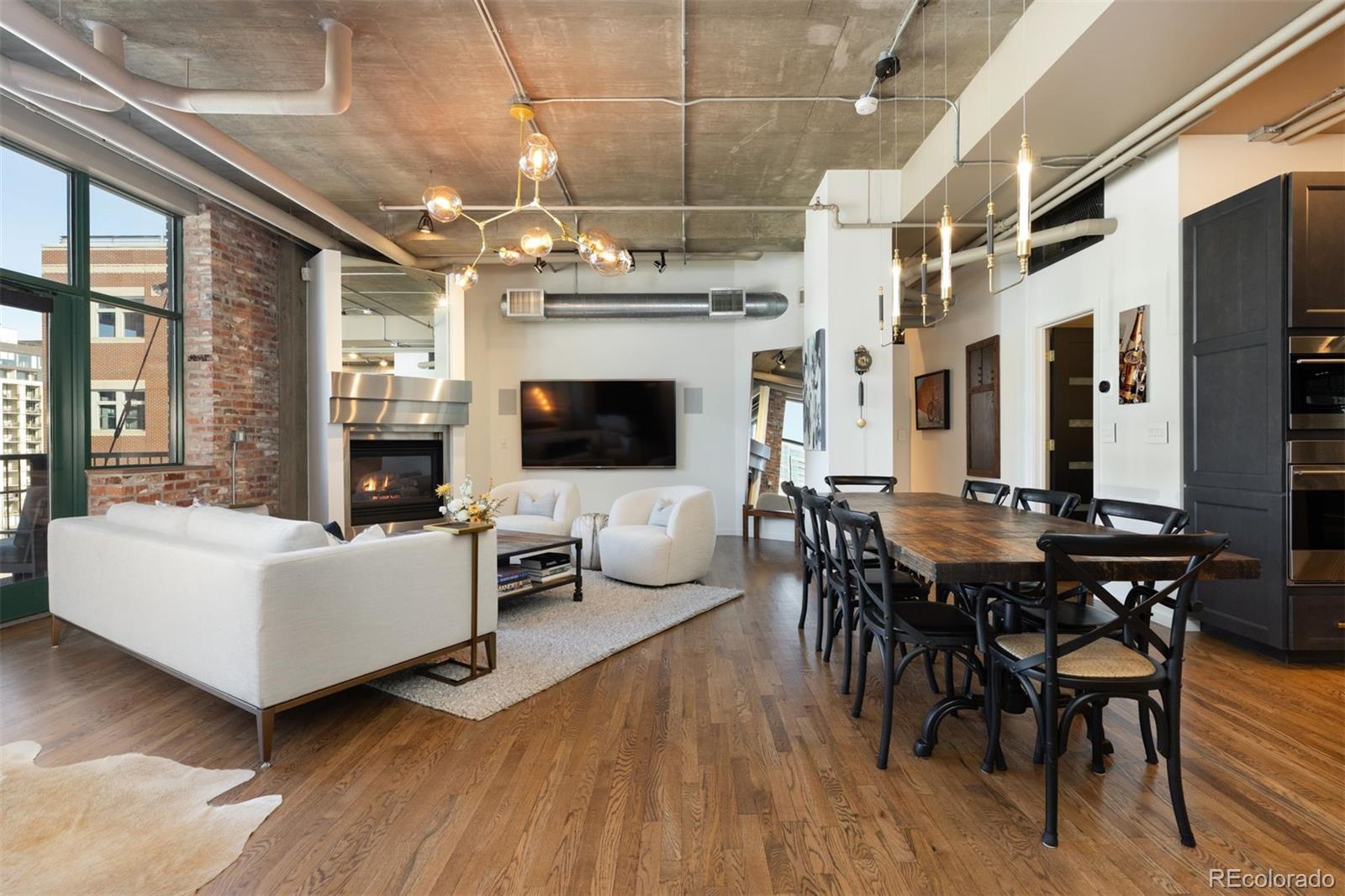 1801 Wynkoop Street, Unit 603 Denver, CO 80202 - Photo 10 of 40 a living room with fireplace furniture and a flat screen tv