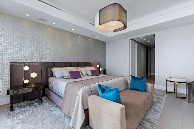 a bedroom with bed and a night stand