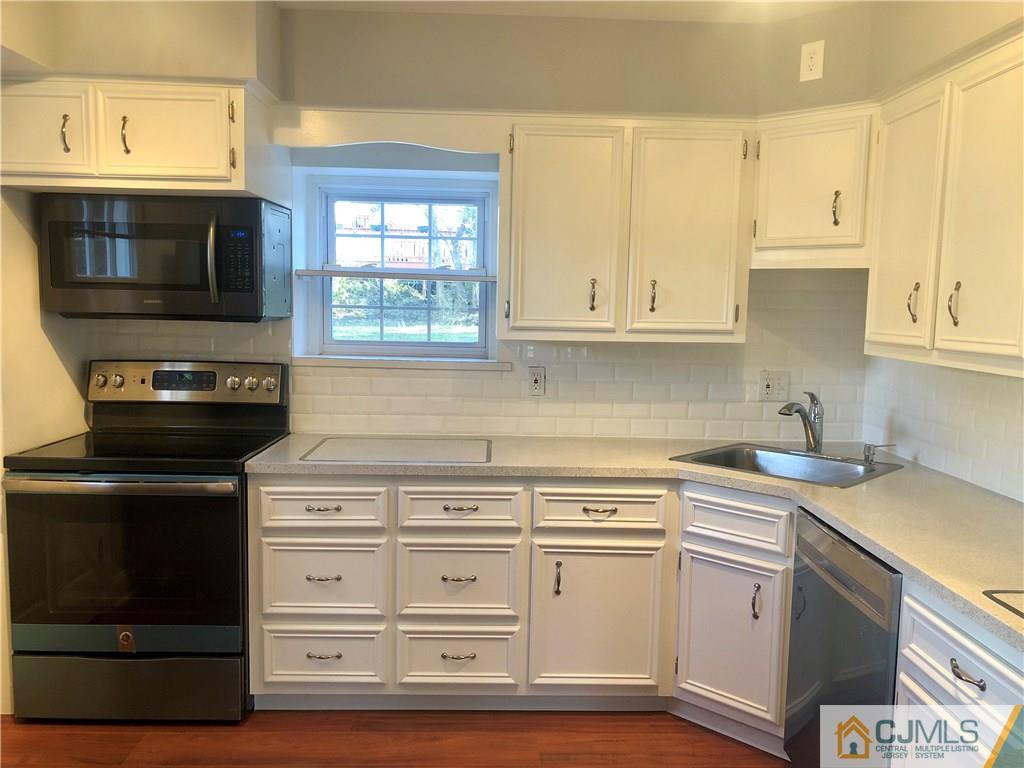 425 Chain O' Hills Road Colonia, NJ 07067 - Photo 2 of 16 a kitchen with a stove and a microwave