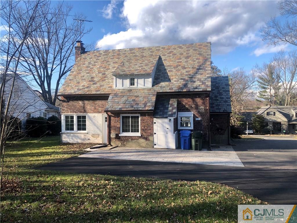 425 Chain O' Hills Road Colonia, NJ 07067 - Photo 14 of 16 a front view of a house with a garden
