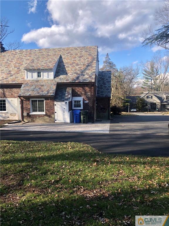 425 Chain O' Hills Road Colonia, NJ 07067 - Photo 15 of 16 a front view of a house with a garden