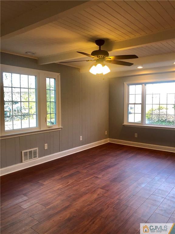 425 Chain O' Hills Road Colonia, NJ 07067 - Photo 4 of 16 a view of an empty room with wooden floor and a window