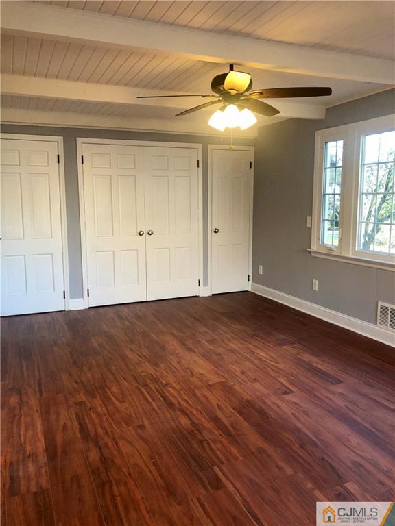 425 Chain O' Hills Road Colonia, NJ 07067 - Photo 5 of 16 a view of empty room with wooden floor and fan