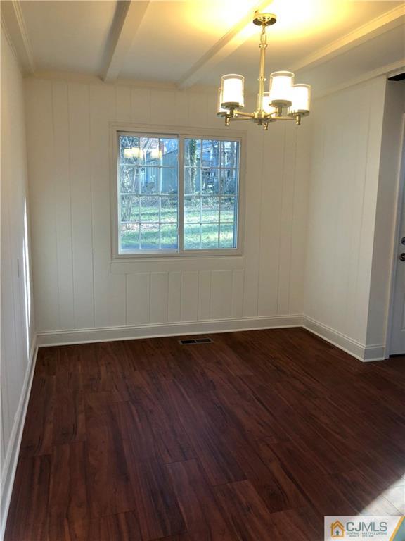 425 Chain O' Hills Road Colonia, NJ 07067 - Photo 6 of 16 an empty room with wooden floor and windows