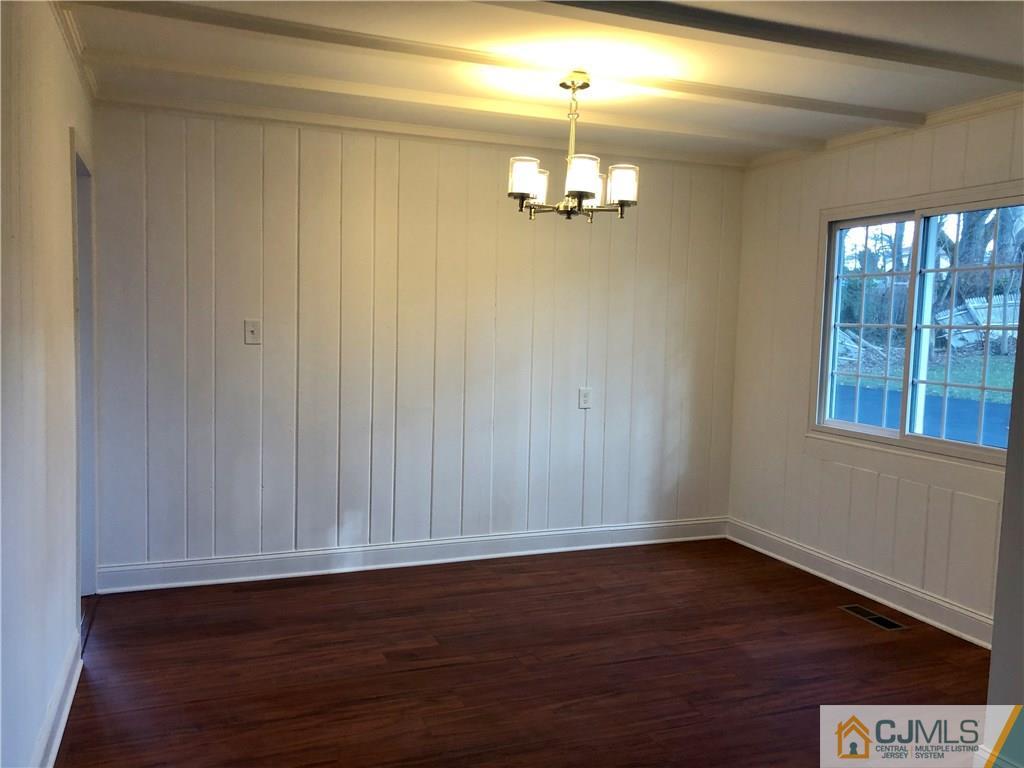 425 Chain O' Hills Road Colonia, NJ 07067 - Photo 7 of 16 a view of empty room with wooden floor and fan