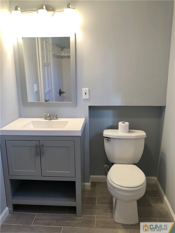 425 Chain O' Hills Road Colonia, NJ 07067 - Photo 9 of 16 a bathroom with a toilet sink and mirror