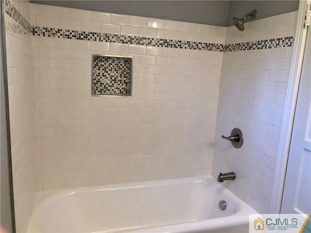 425 Chain O' Hills Road Colonia, NJ 07067 - Photo 10 of 16 a bathroom with a shower and a bath tub