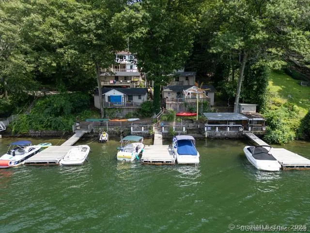 a front view of a house with swimming pool garden and patio
