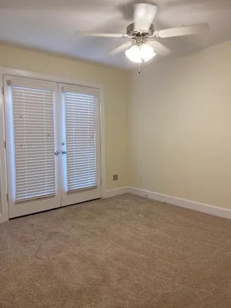 a view of empty room with wooden floor and fireplace