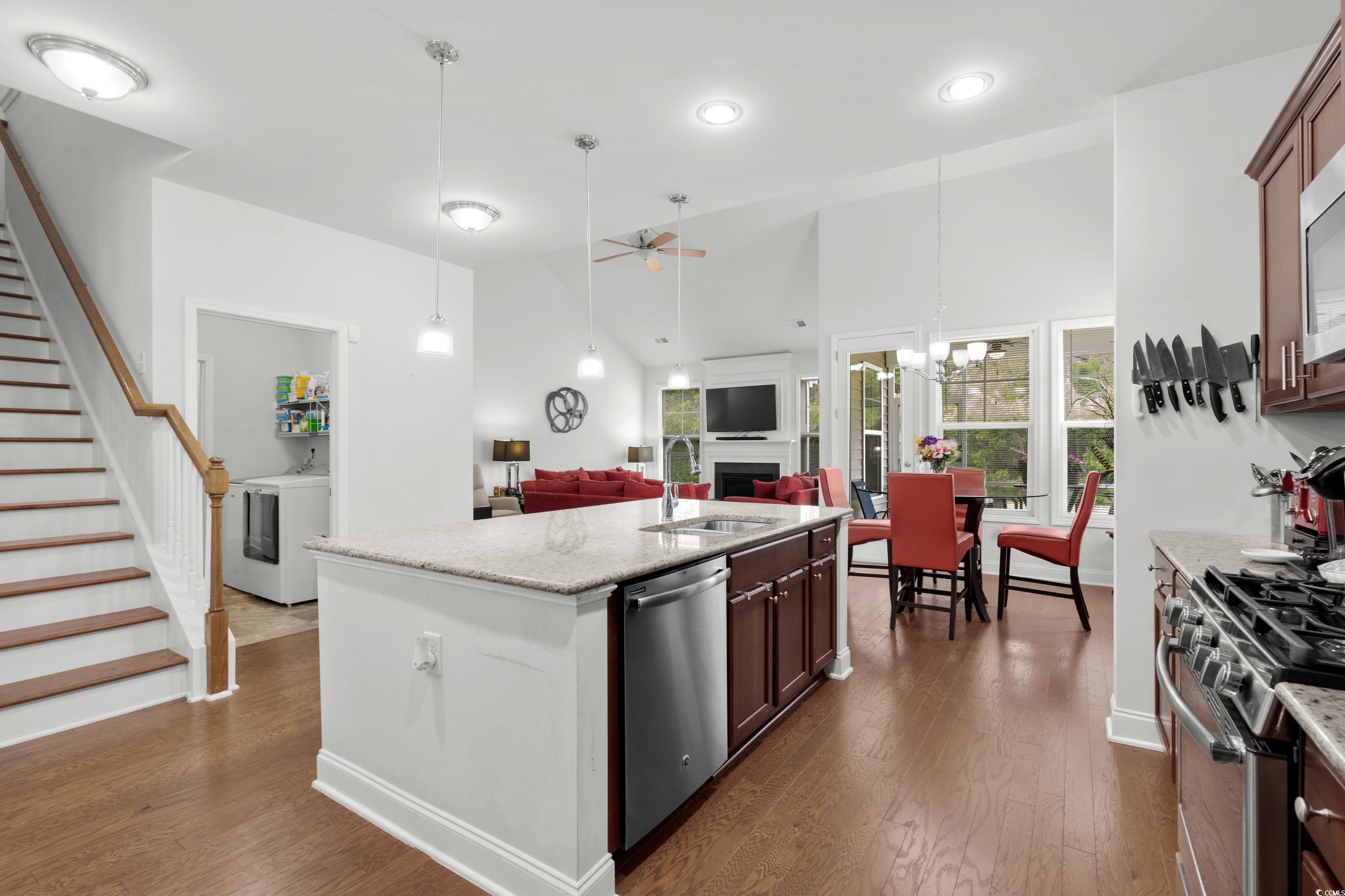 4246 Livorn Loop Myrtle Beach, SC 29579 - Photo 14 of 40 Kitchen featuring a sink, washer / dryer, dark wood-type flooring, a ceiling fan, and appliances with stainless steel finishes