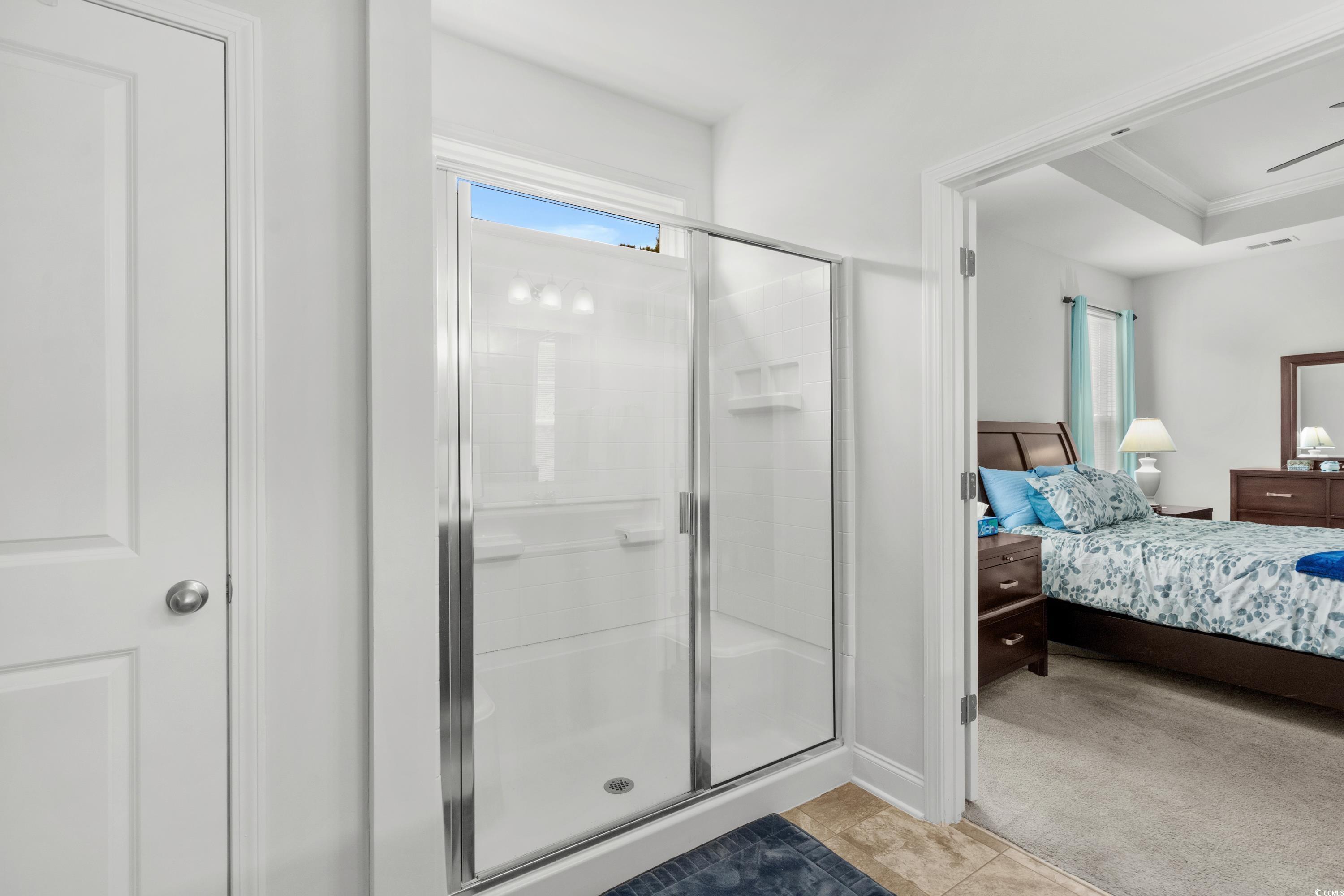 4246 Livorn Loop Myrtle Beach, SC 29579 - Photo 19 of 40 Ensuite bathroom with a stall shower, crown molding, ensuite bathroom, and tile patterned flooring