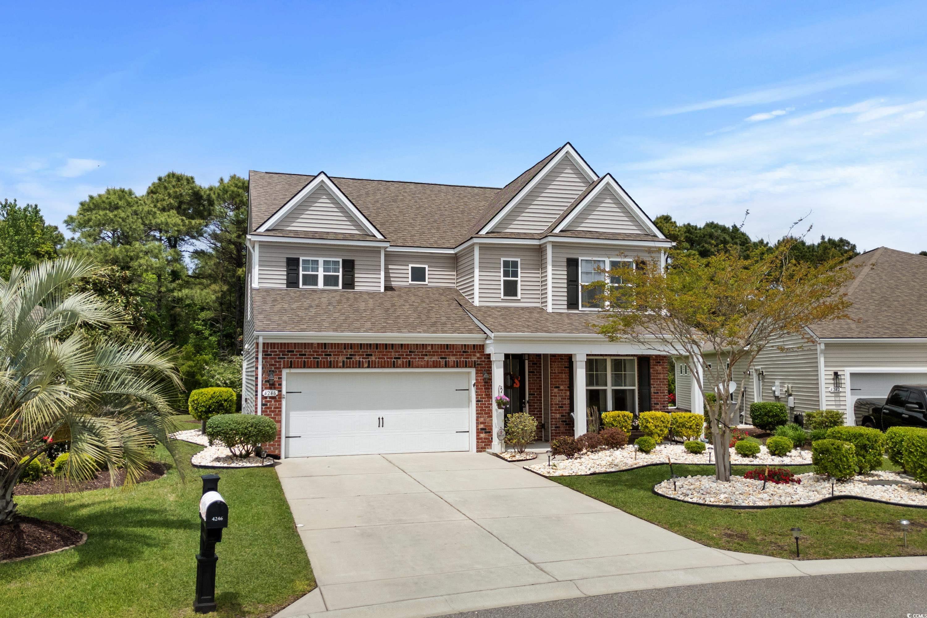 4246 Livorn Loop Myrtle Beach, SC 29579 - Photo 2 of 40 Craftsman inspired home with driveway, brick siding, a garage, a shingled roof, and a front yard