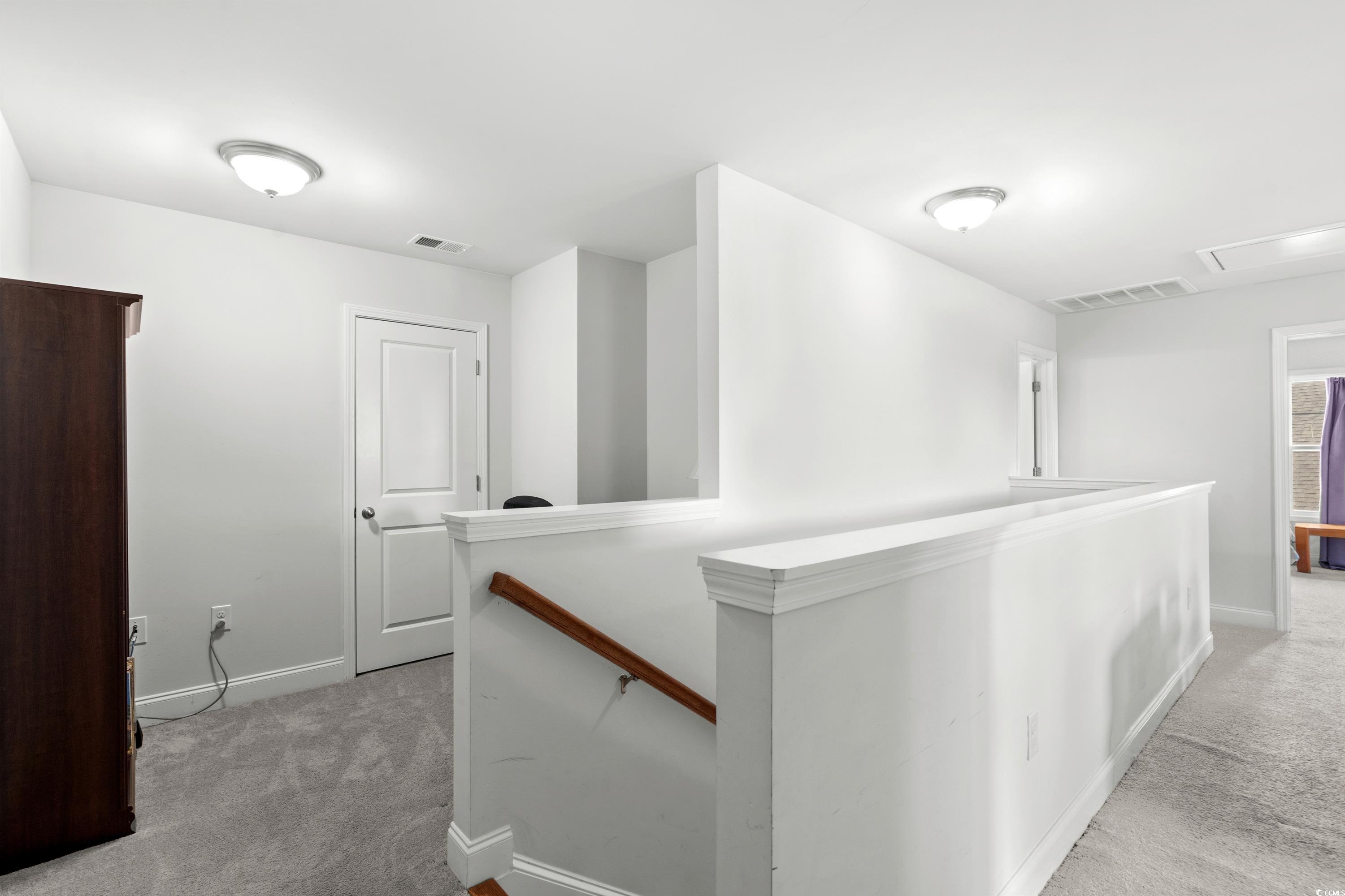 4246 Livorn Loop Myrtle Beach, SC 29579 - Photo 22 of 40 Hall with baseboards, carpet flooring, an upstairs landing, and visible vents