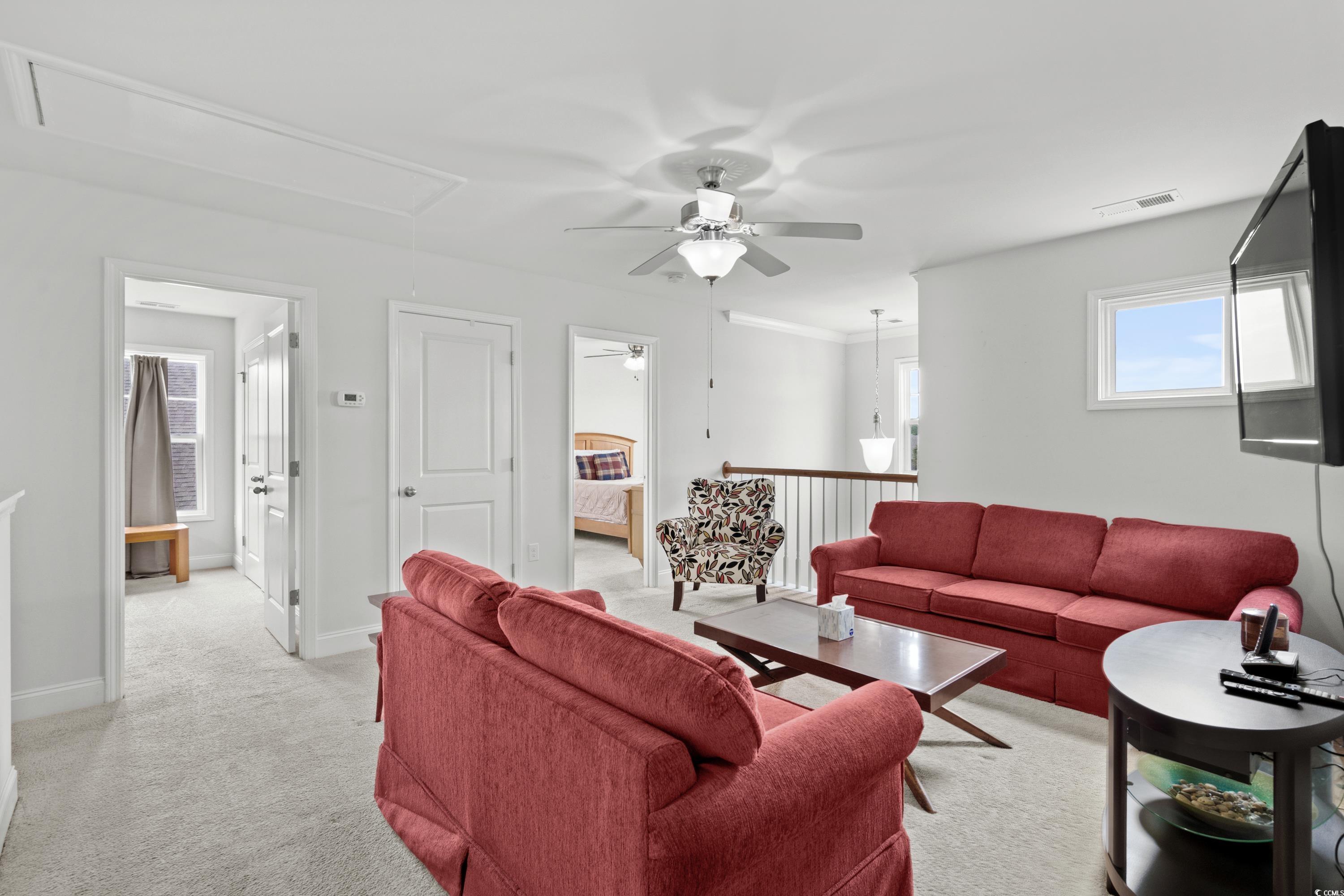 4246 Livorn Loop Myrtle Beach, SC 29579 - Photo 24 of 40 Living area with attic access, baseboards, ceiling fan, visible vents, and light colored carpet