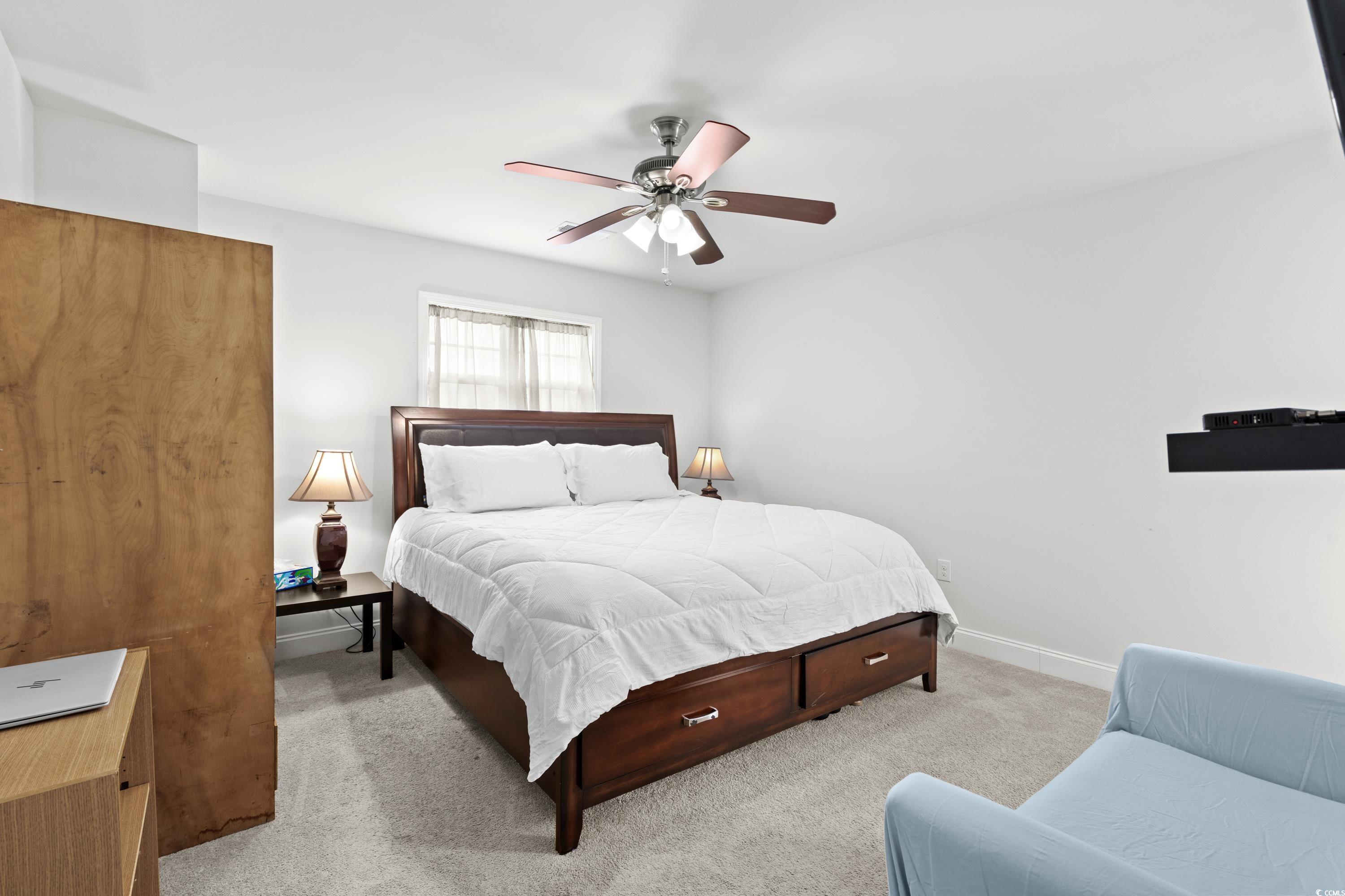 4246 Livorn Loop Myrtle Beach, SC 29579 - Photo 25 of 40 Bedroom with light colored carpet, baseboards, and ceiling fan