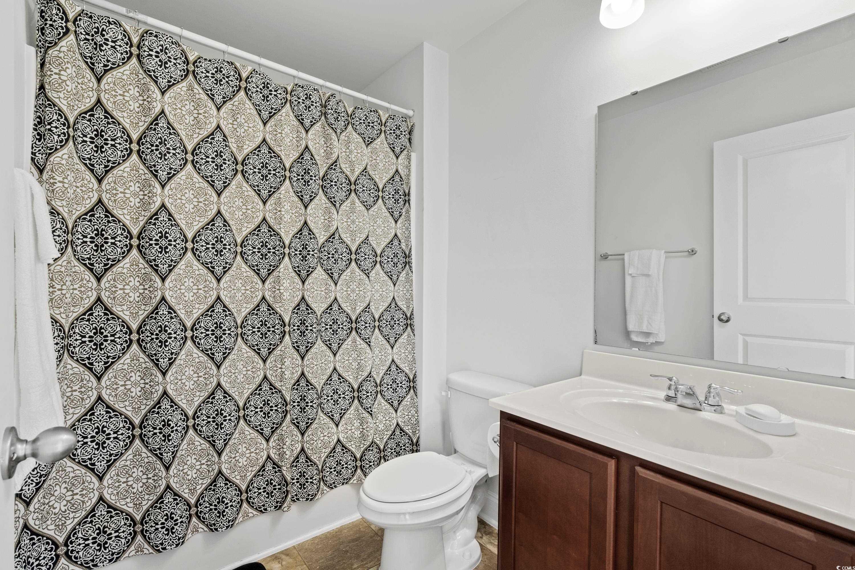 4246 Livorn Loop Myrtle Beach, SC 29579 - Photo 27 of 40 Full bathroom featuring curtained shower, vanity, toilet, and tile patterned floors
