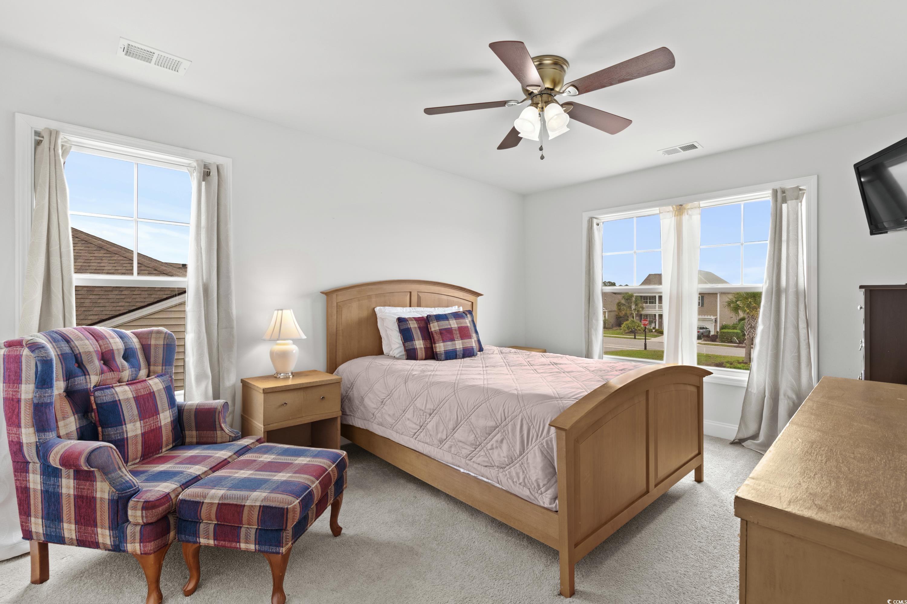 4246 Livorn Loop Myrtle Beach, SC 29579 - Photo 28 of 40 Bedroom with multiple windows, visible vents, and light colored carpet