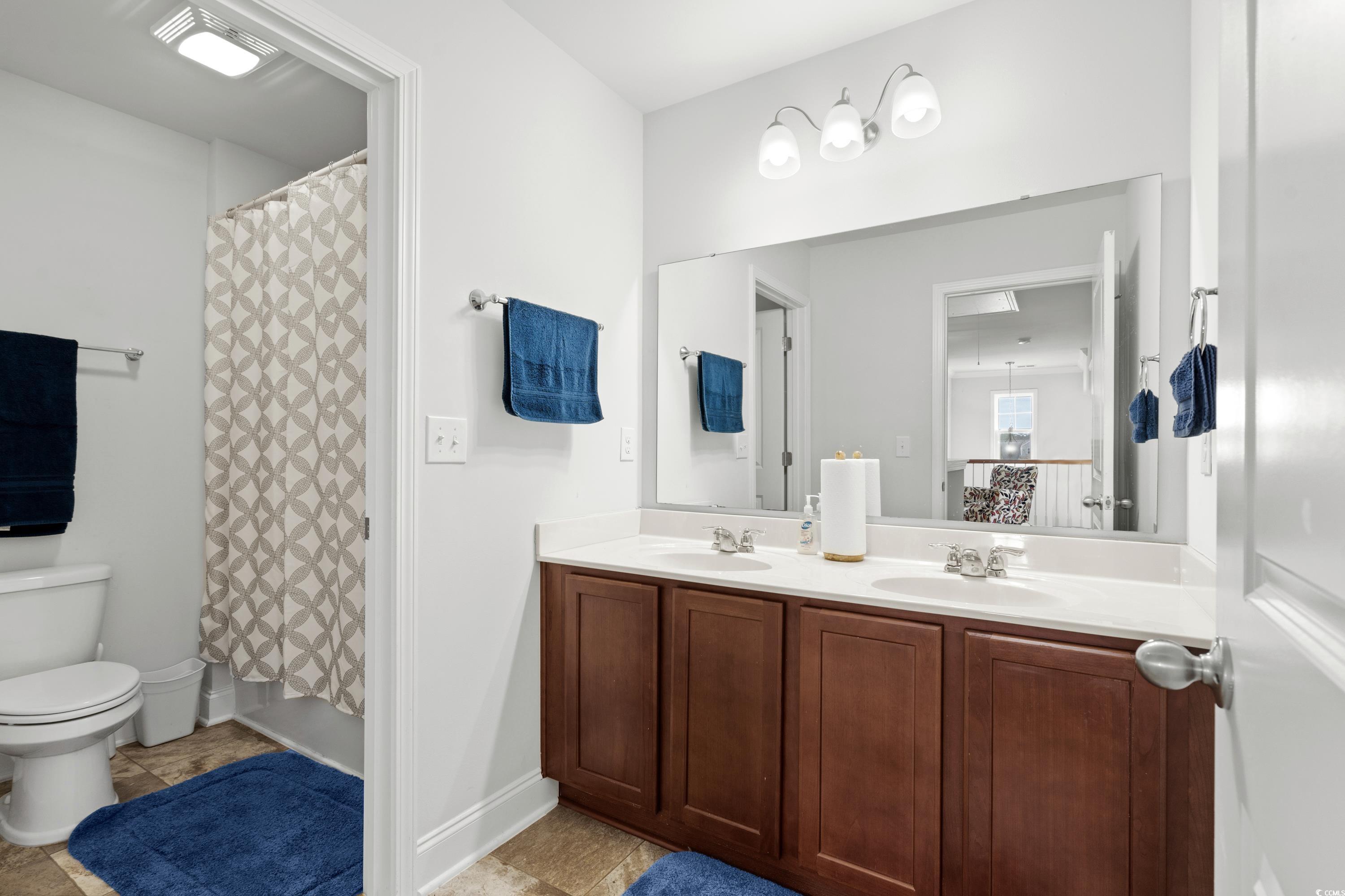 4246 Livorn Loop Myrtle Beach, SC 29579 - Photo 30 of 40 Full bath featuring toilet, tile patterned flooring, double vanity, and a sink