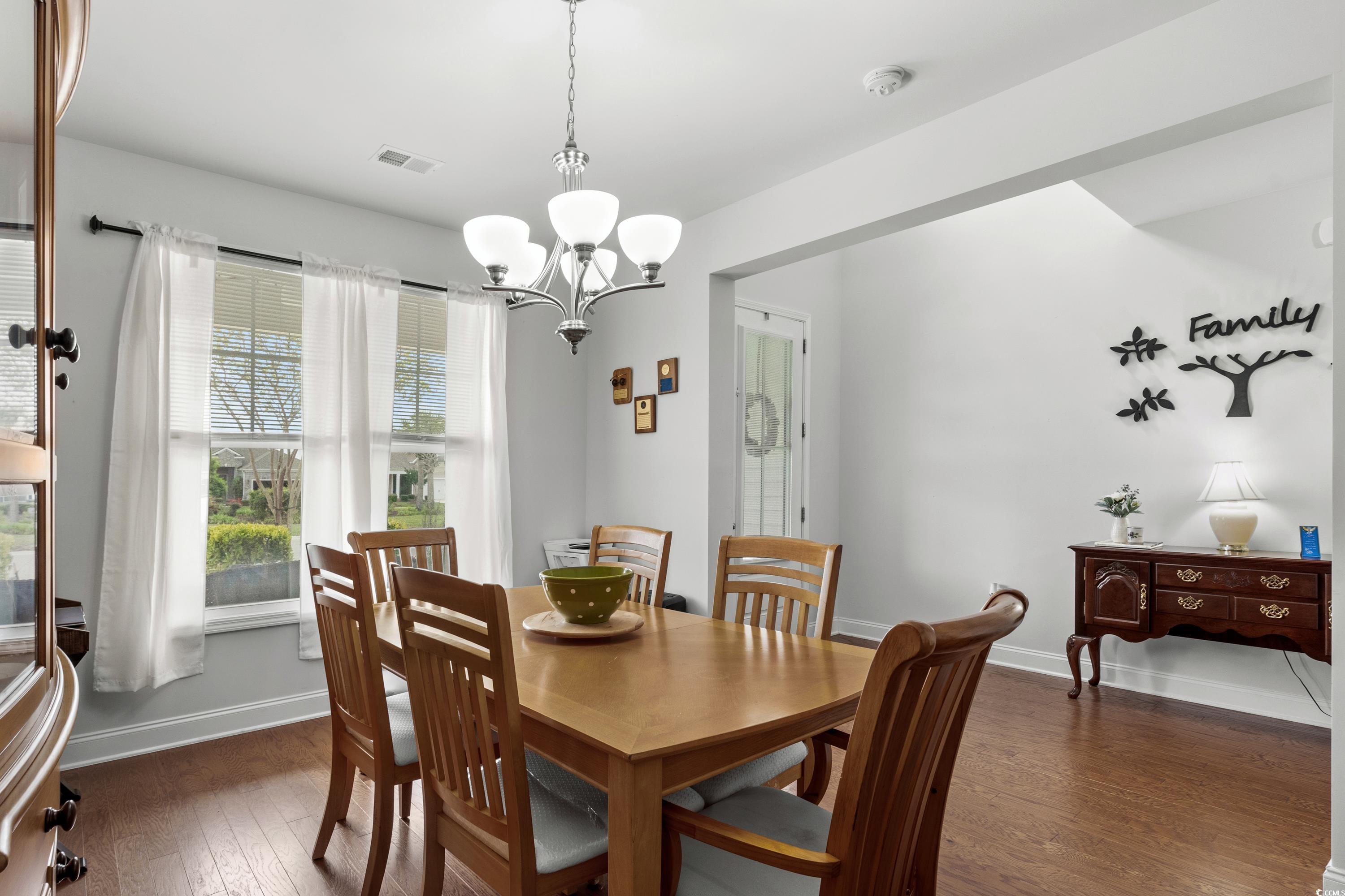4246 Livorn Loop Myrtle Beach, SC 29579 - Photo 8 of 40 Dining area featuring baseboards, a chandelier, visible vents, and dark wood-style floors